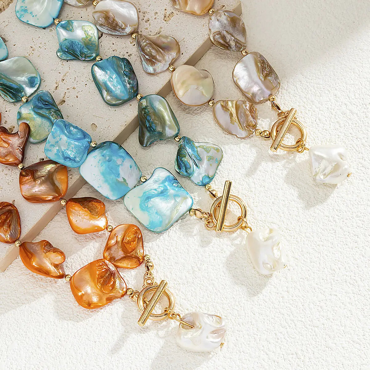 Nacre baroque shell choker, all colorways flatlay