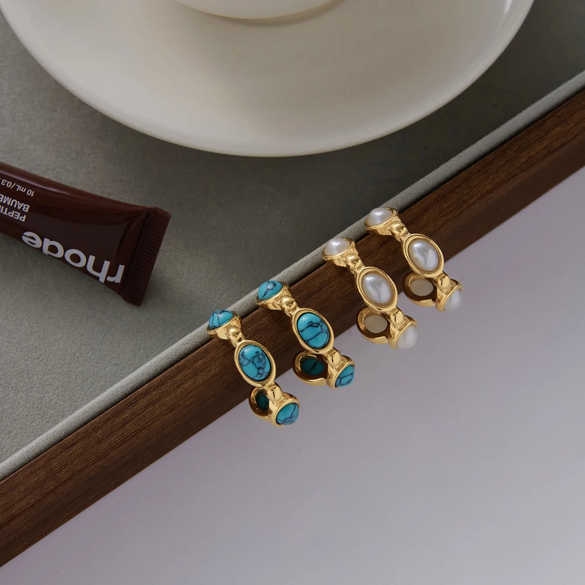 Santorini earrings styled on tray, both colorways