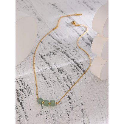 Juniper Aventurine Pendant Necklace laid flat on a textured surface
