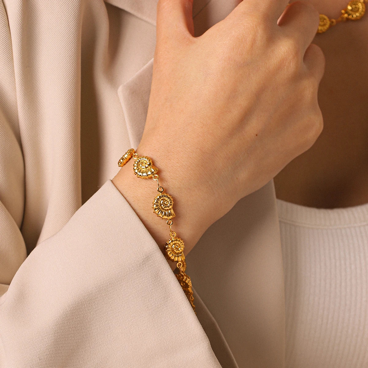 Marisol gold-tone seashell bracelet on wrist