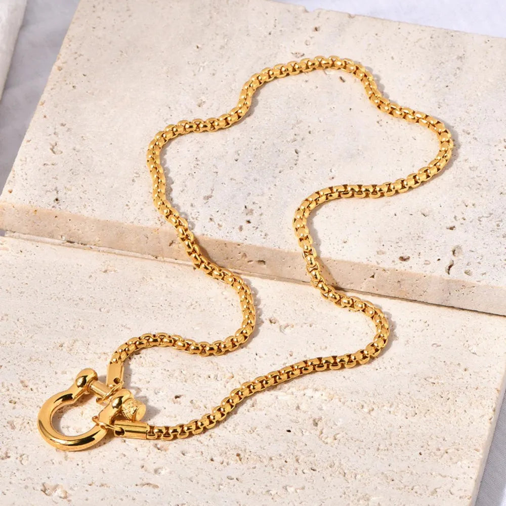Lido gold horseshoe necklace flat lay