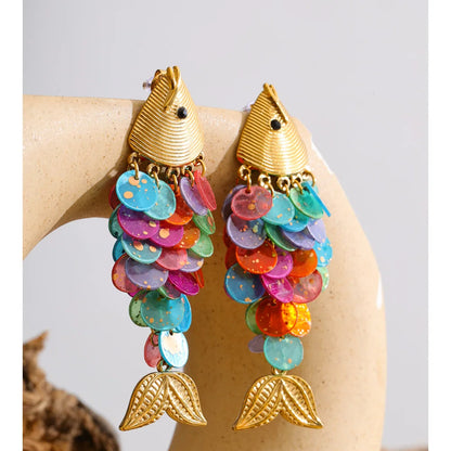 Odessa multicolor resin fish drop earrings styled on a ceramic stand