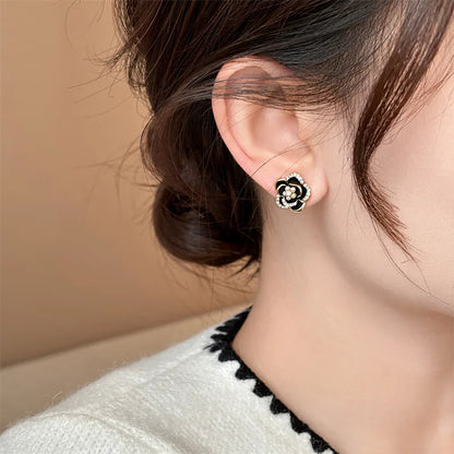 Camellia earrings worn on ear