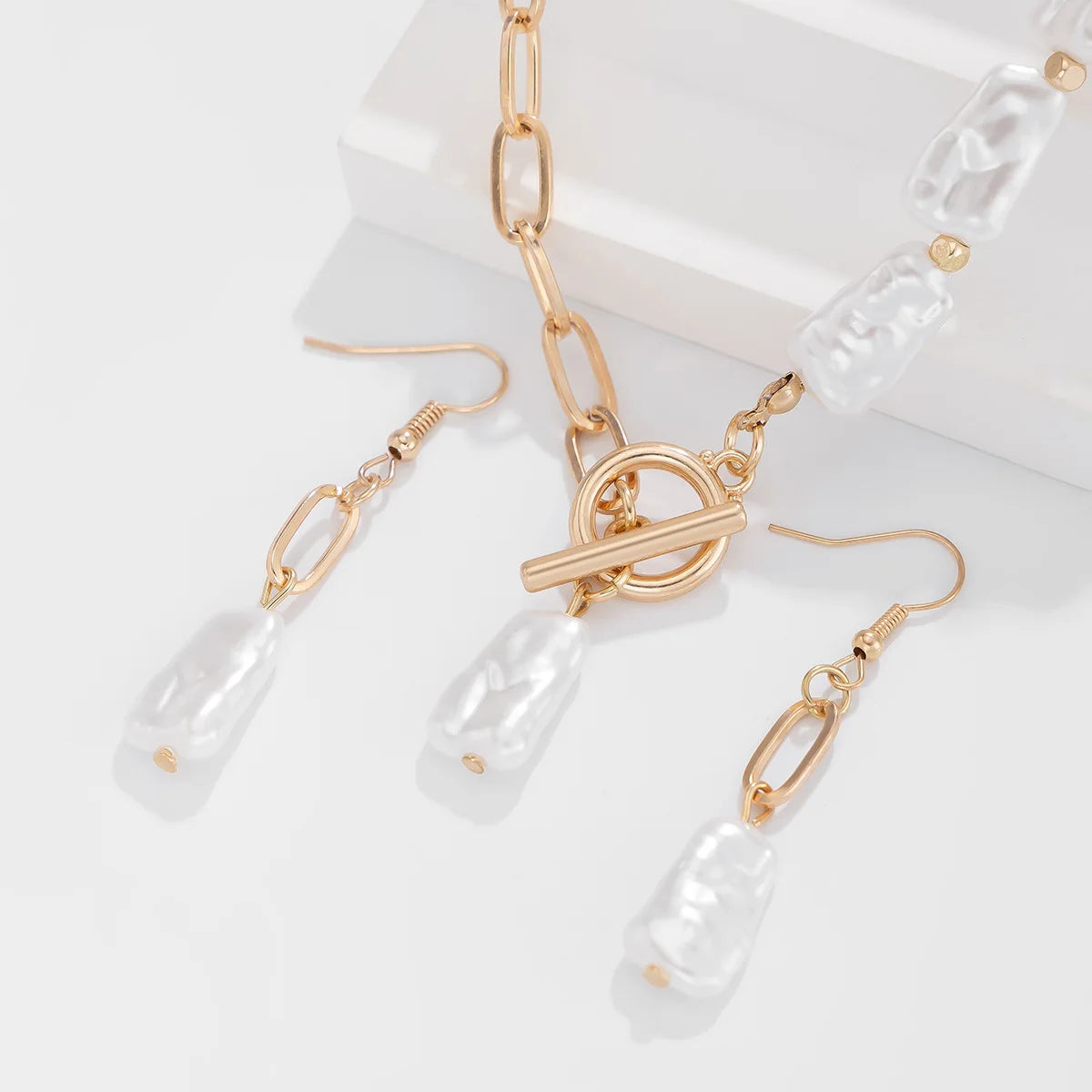 Isolde gold toggle clasp and drop earrings close up