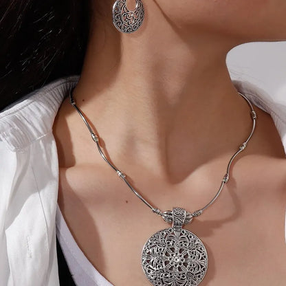 Lucca medallion necklace and earrings worn