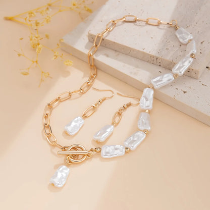 Isolde baroque pearl necklace and earrings styled flat lay
