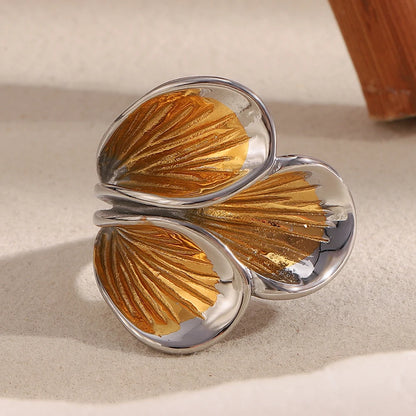 Flora Petal Cocktail Ring in silver and 18k gold PVD, styled on a wood accent