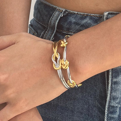 Noa two-tone knotted bangle worn on the wrist