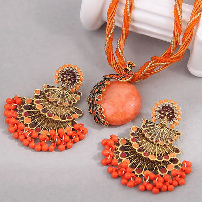 Alba Beaded Peacock Jewelry Set in Coral Orange, necklace and fan earrings flat lay