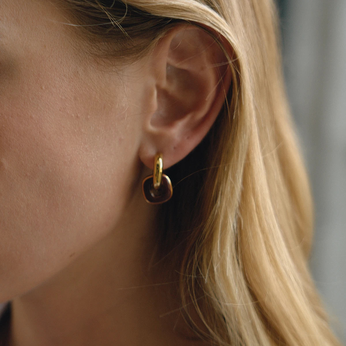 Noor burgundy enamel earring on model