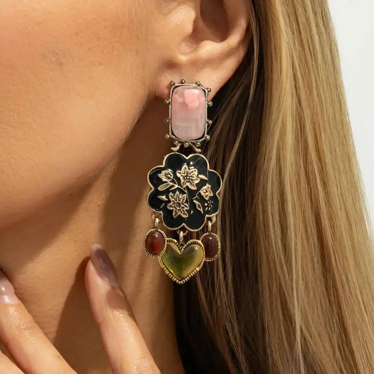 Close side view of Bellamy vintage floral drop earring worn on the ear