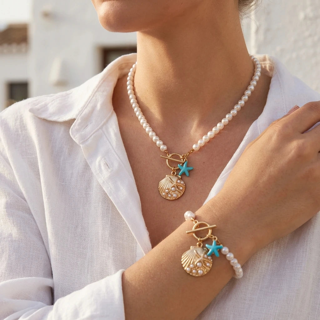 Close view of the Cove imitation pearl strand necklace and matching bracelet worn together