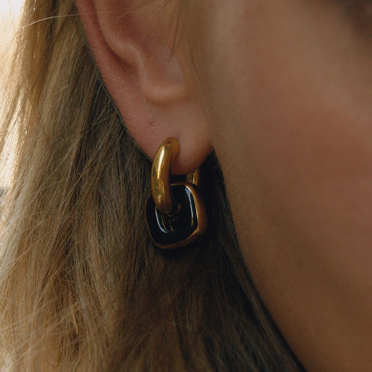 Noor black enamel earring on model