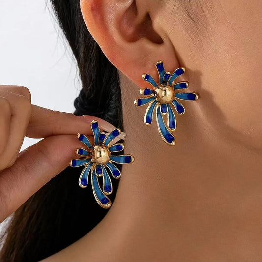 Solene blue enamel starburst earrings on model