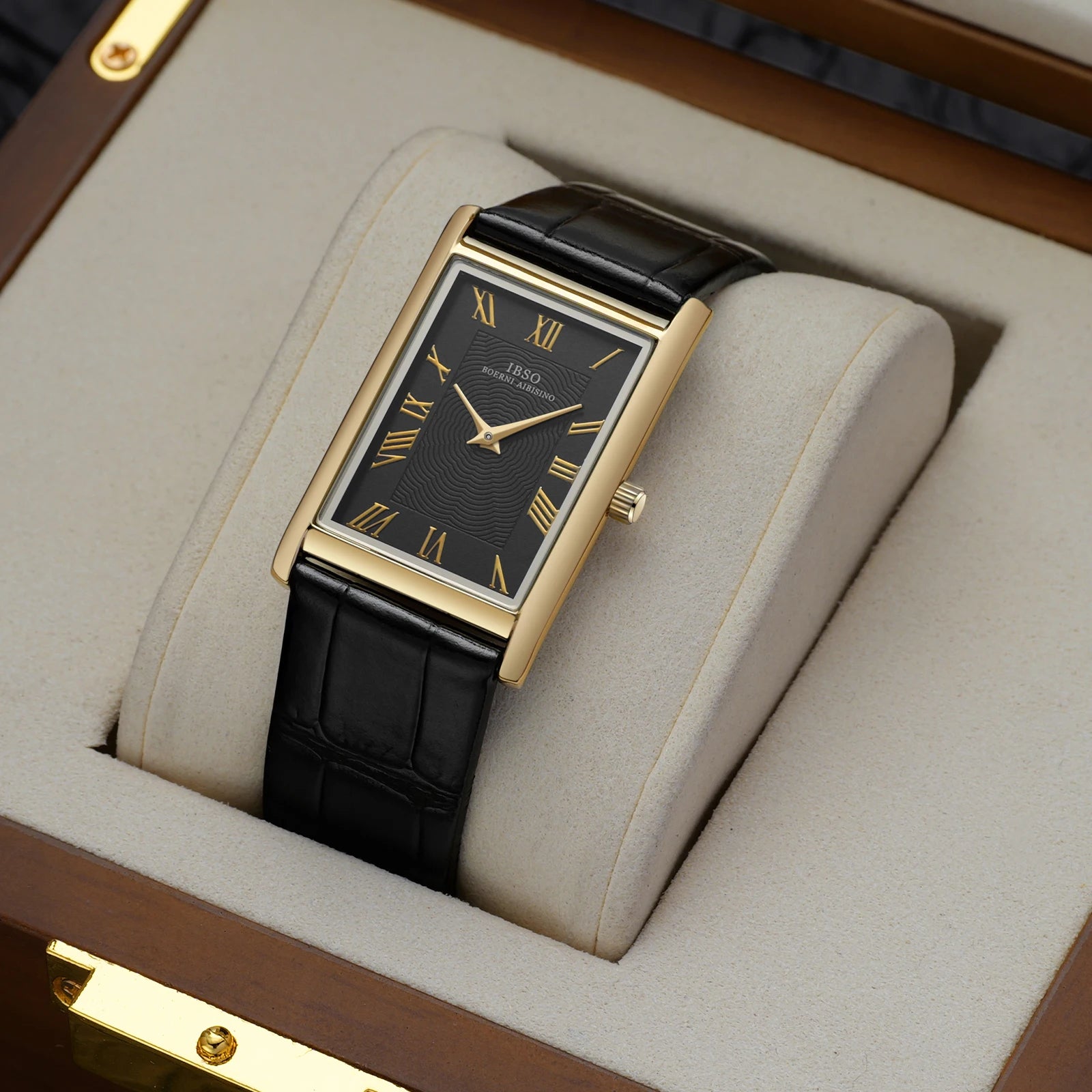Carlyle rectangular dress watch, gold-tone case with black dial resting in a wooden presentation box