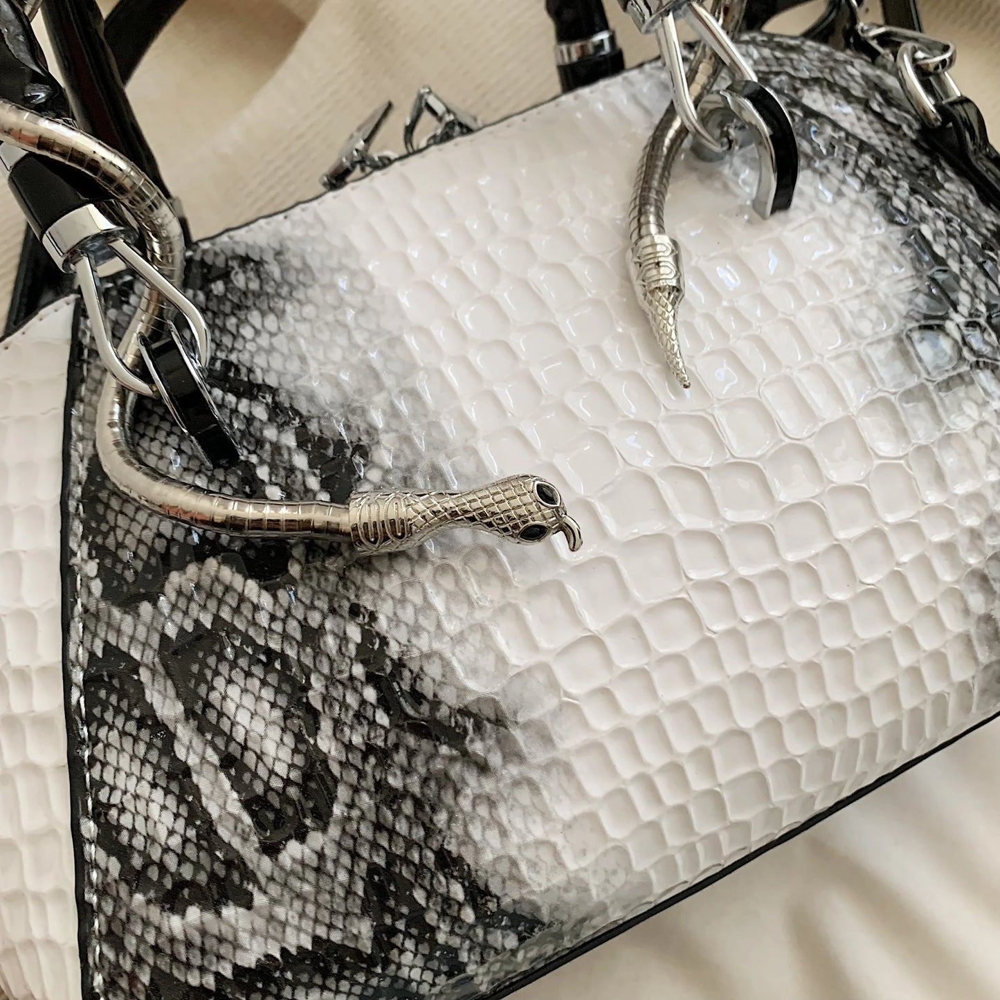 Renata white snake-print top-handle bag detail