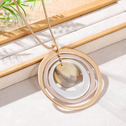 Linnea Layered Disc Necklace styled on a linen surface