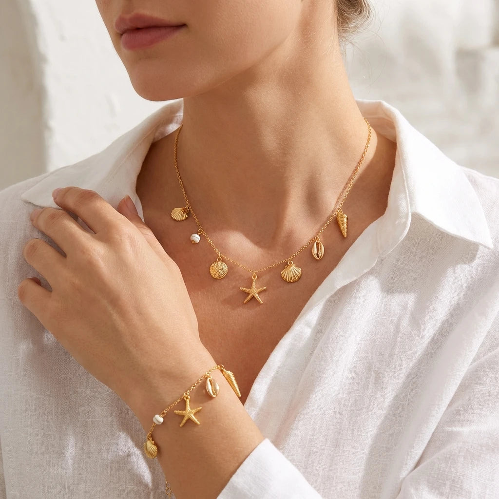 Close view of the Cove gold-tone shell charm chain necklace and bracelet