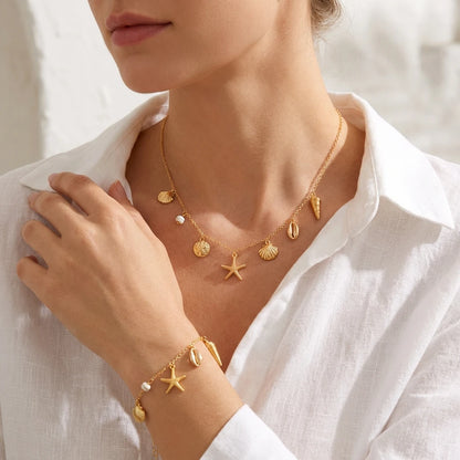 Close view of the Cove gold-tone shell charm chain necklace and bracelet