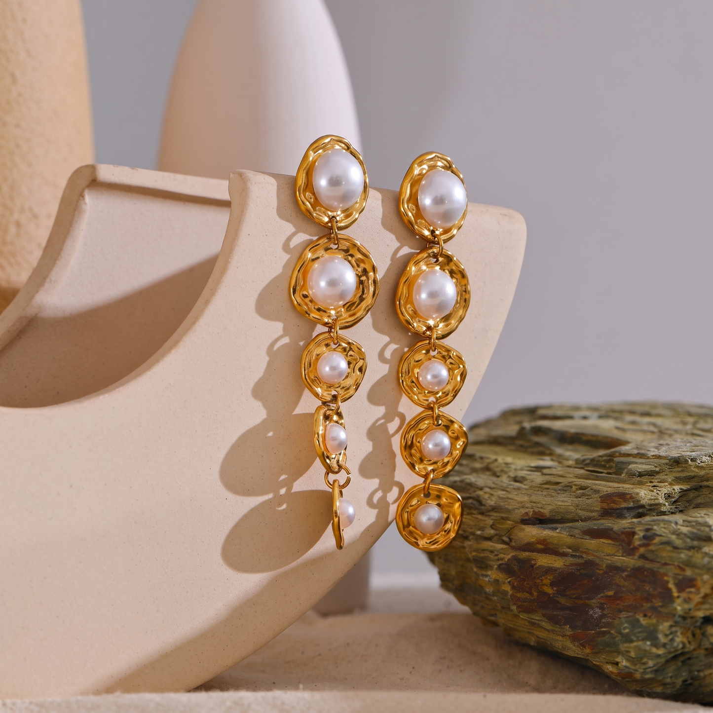 Amelie gold pearl drop earrings styled flat lay
