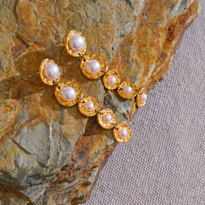Amelie gold pearl drop earrings on stone
