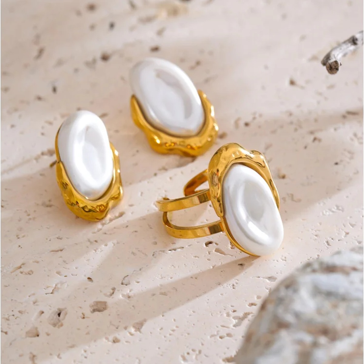Anya faux pearl stud earrings and open ring styled on a stone surface