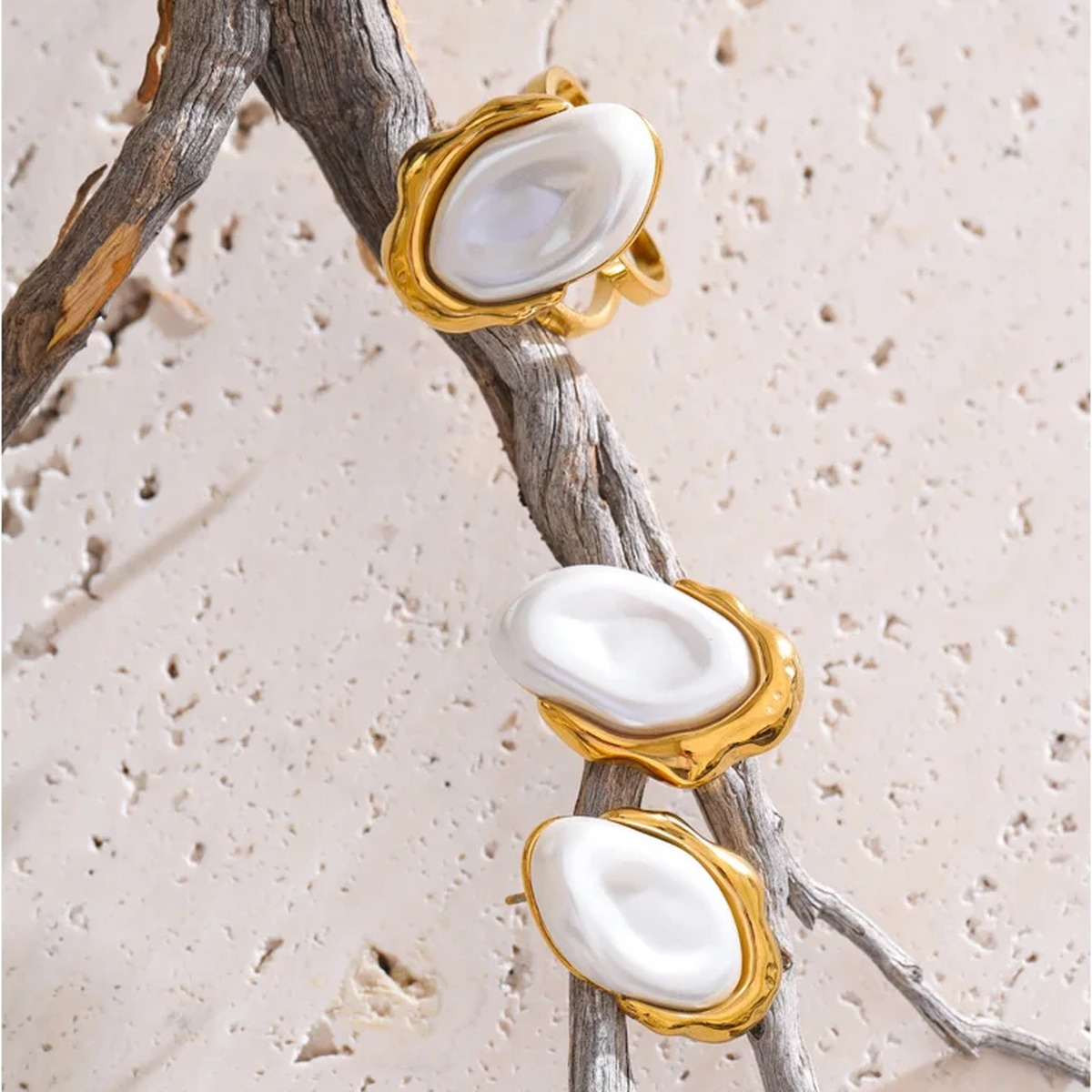 Anya faux pearl earrings and ring resting on a driftwood branch