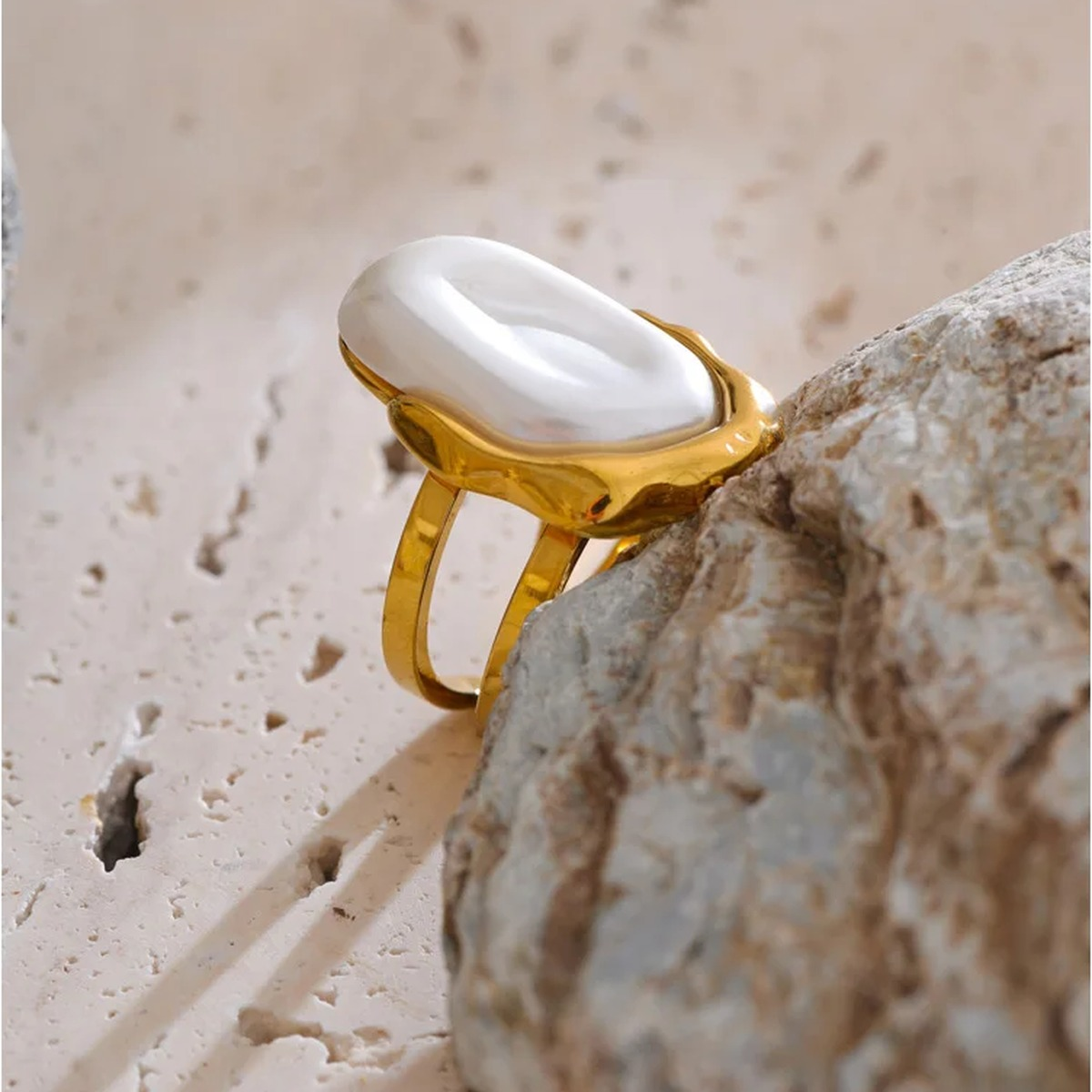 Close up of the Anya gold-tone open ring with imitation pearl