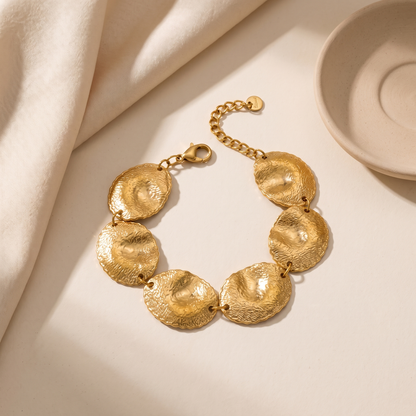 Blakely hammered gold-tone disc bracelet on a white background