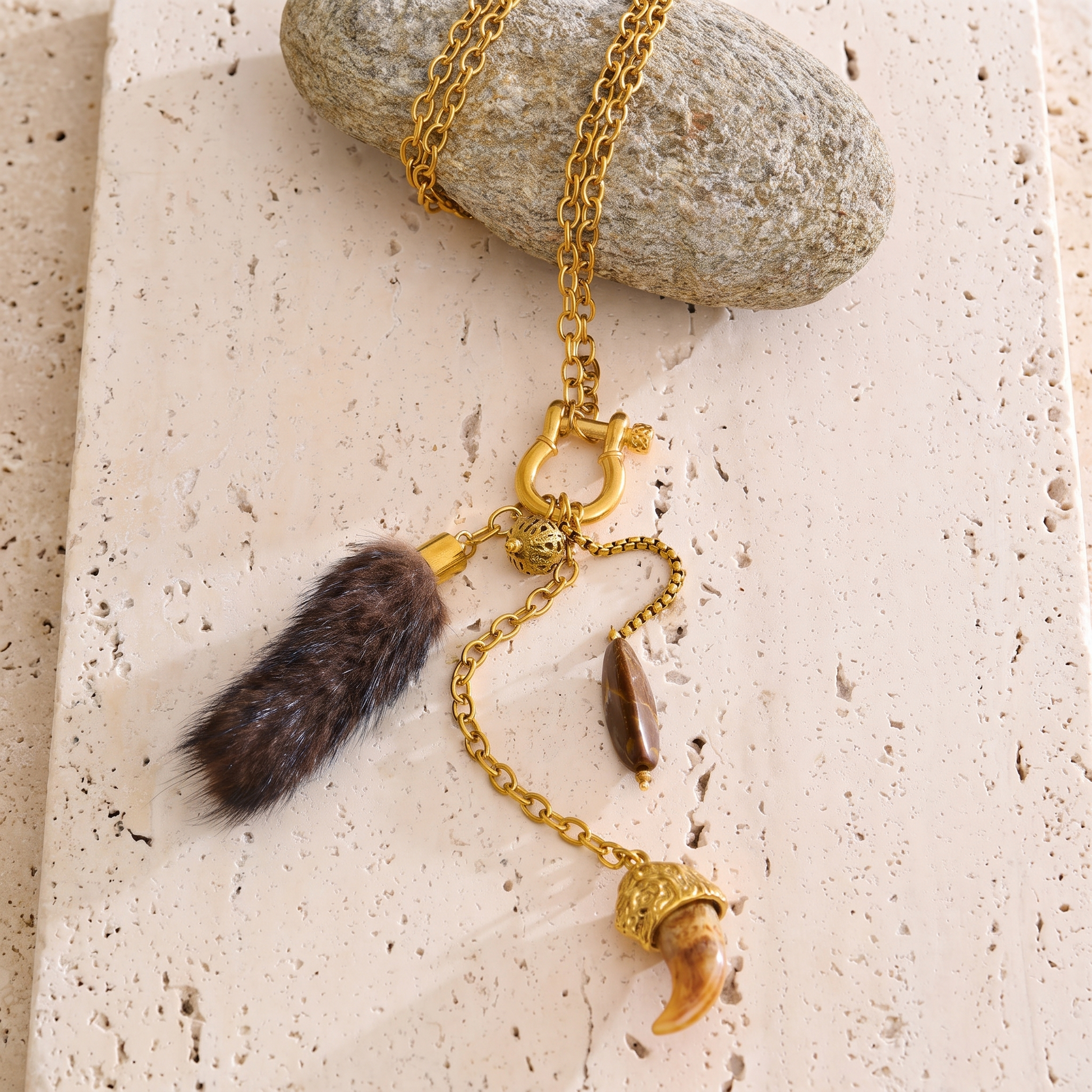 Briar Charm Carabiner Necklace laid flat with gold chain, faux fur tassel, and resin claw charm