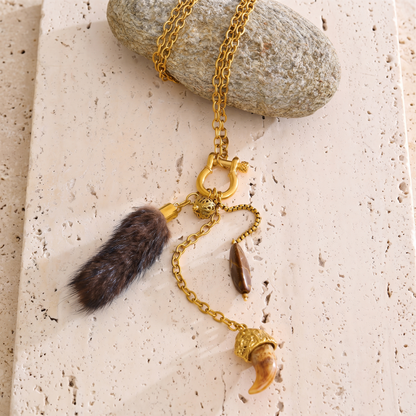 Briar Charm Carabiner Necklace laid flat with gold chain, faux fur tassel, and resin claw charm