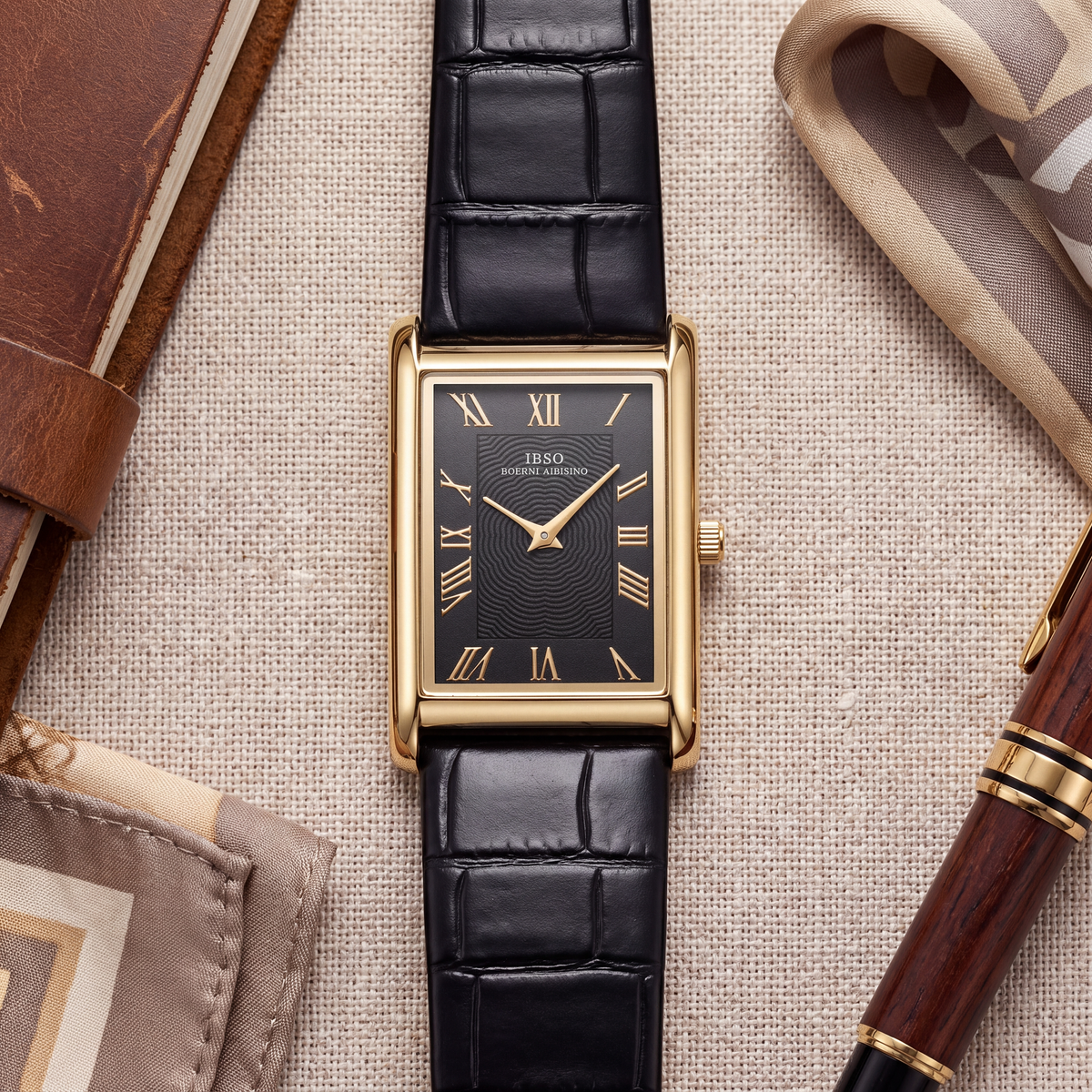 Carlyle rectangular dress watch in gold-tone laid flat on linen with a leather journal and fountain pen