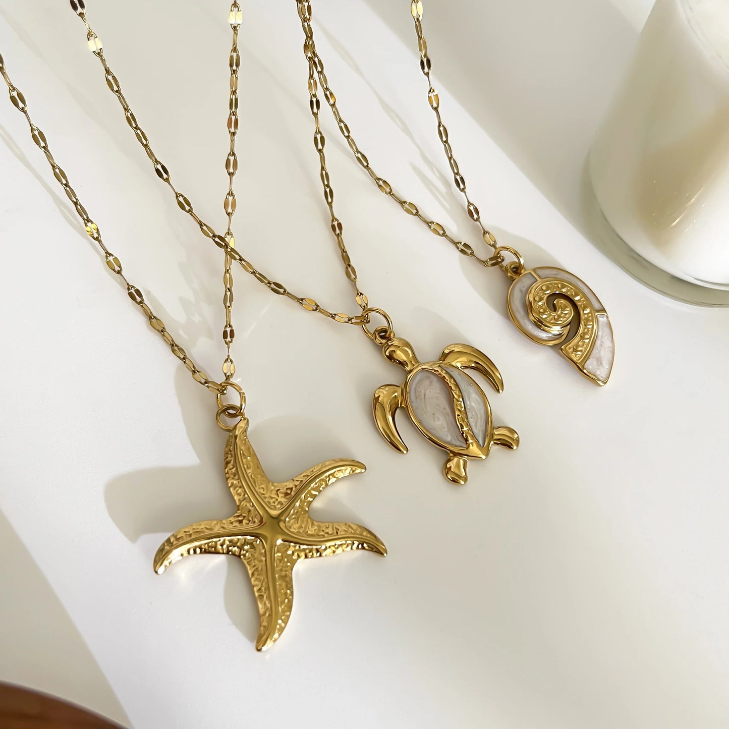 Corsica sea charm necklace set styled flat lay