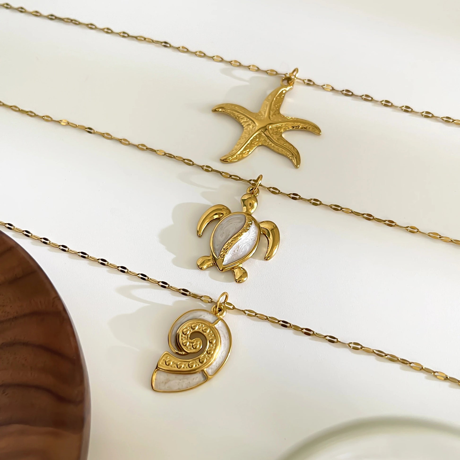 Corsica sea charm necklace set styled flat lay