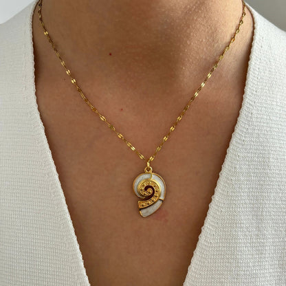 Corsica gold conch shell pendant necklace worn on a model
