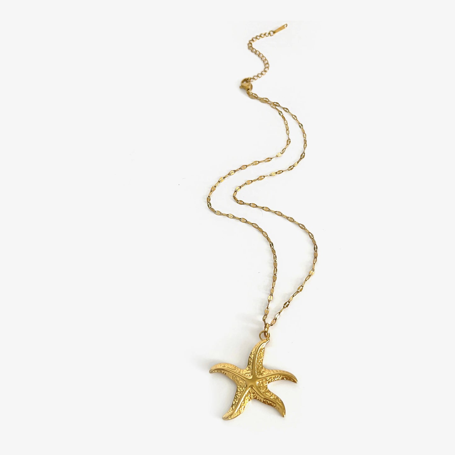 Corsica gold starfish pendant necklace laid flat