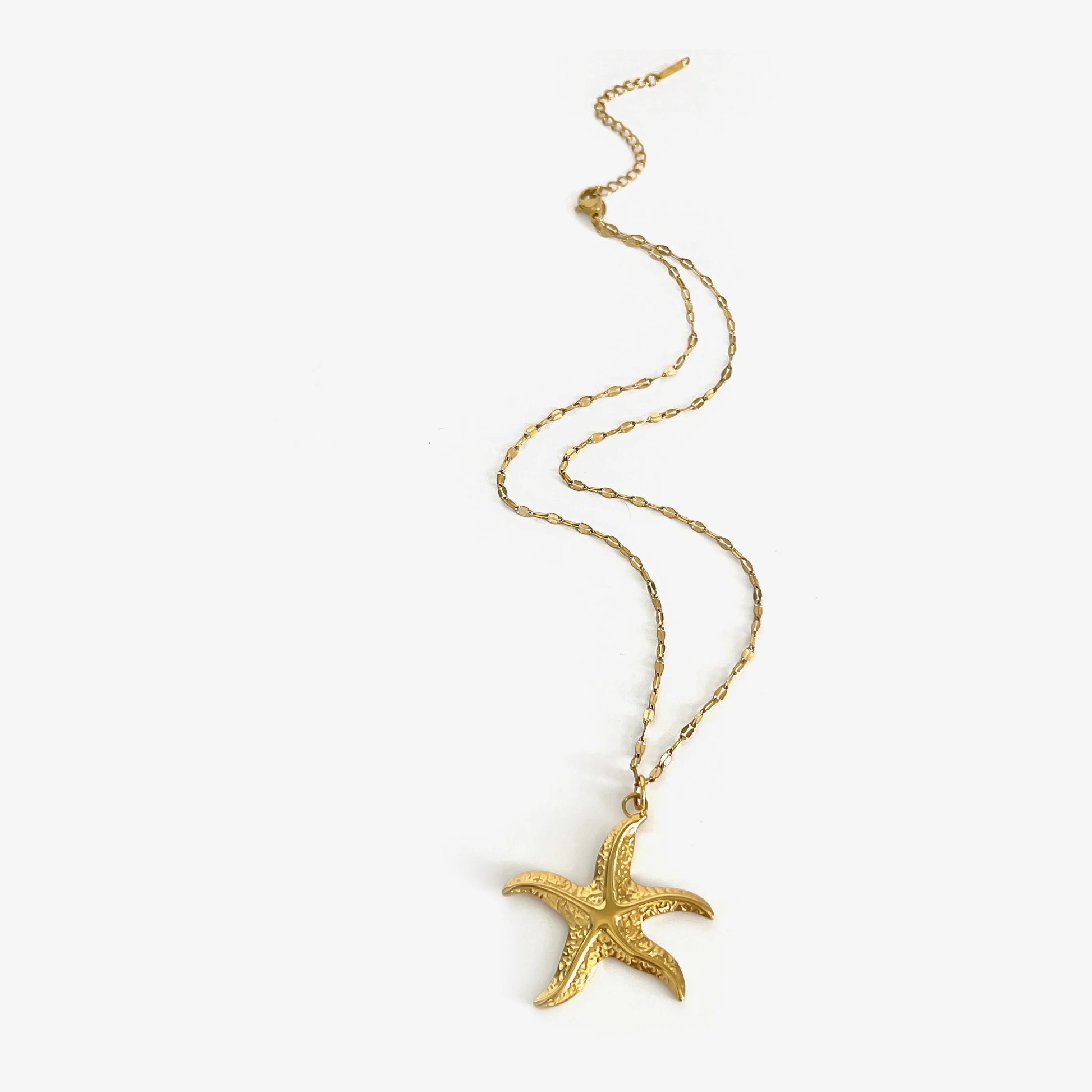 Corsica gold starfish pendant necklace laid flat