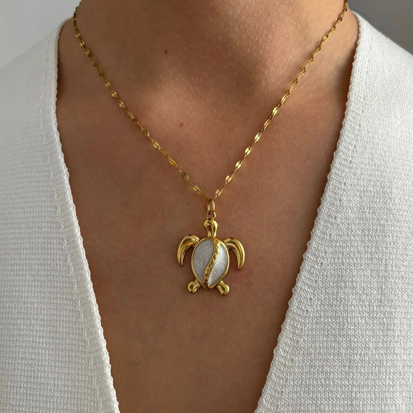 Corsica gold sea turtle pendant necklace worn on a model