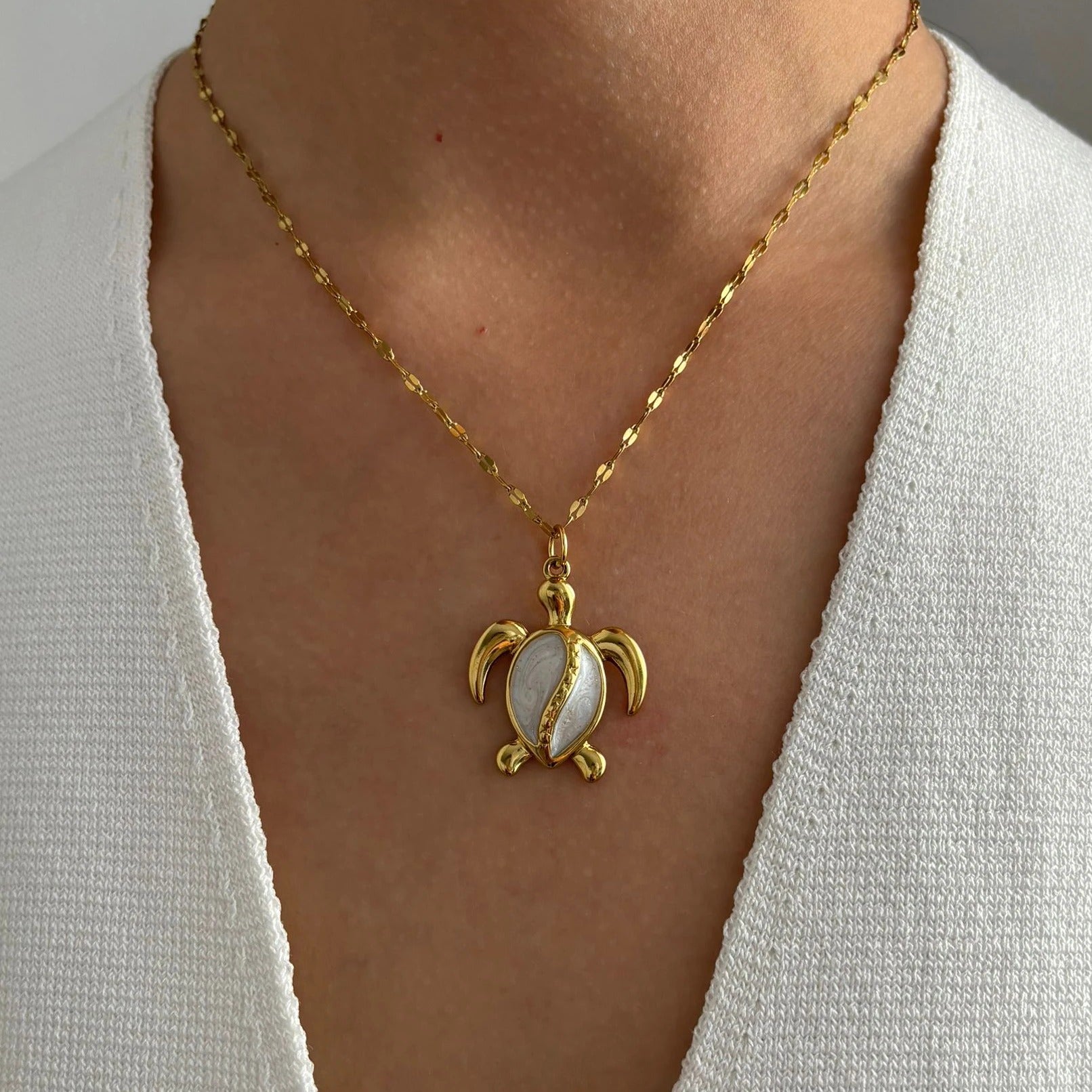 Corsica gold sea turtle pendant necklace worn on a model