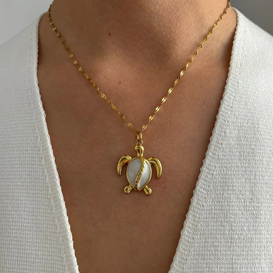 Corsica gold sea turtle pendant necklace worn on a model