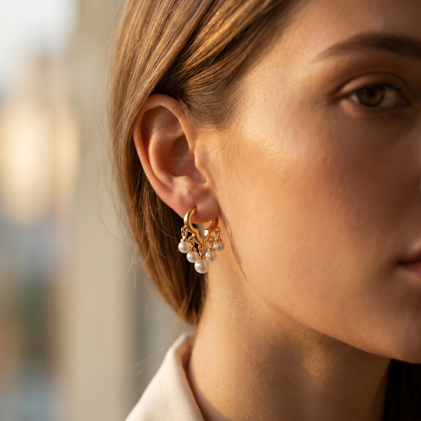 Daisy gold pearl huggie earring close-up