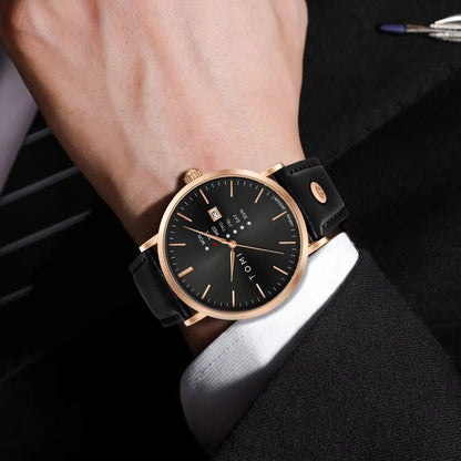 Dalton Calendar Watch in rose gold worn on the wrist with a suit cuff