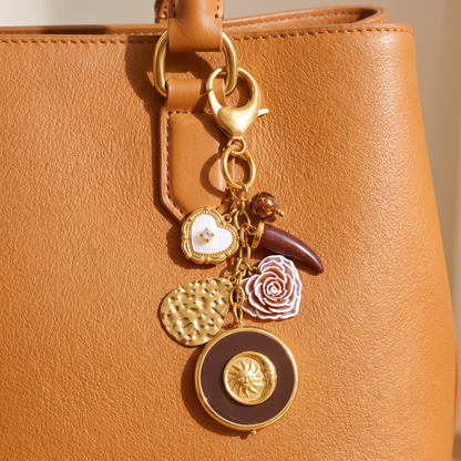 Elba-Sun-Charm-Keyring Gold Burgundy — on model