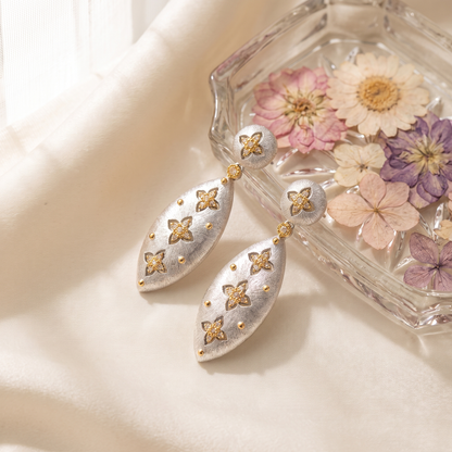 Elena Brushed Clover Drop Earrings styled with pressed flowers