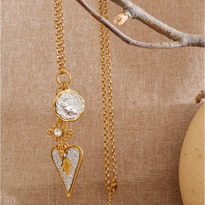 Elise Heart Charm Necklace styled with natural branch and linen