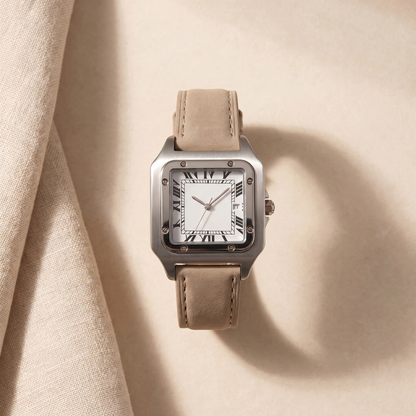 Ellis Sand Suede Square Watch styled flat on soft sand-toned linen, brushed steel square case with sand suede strap