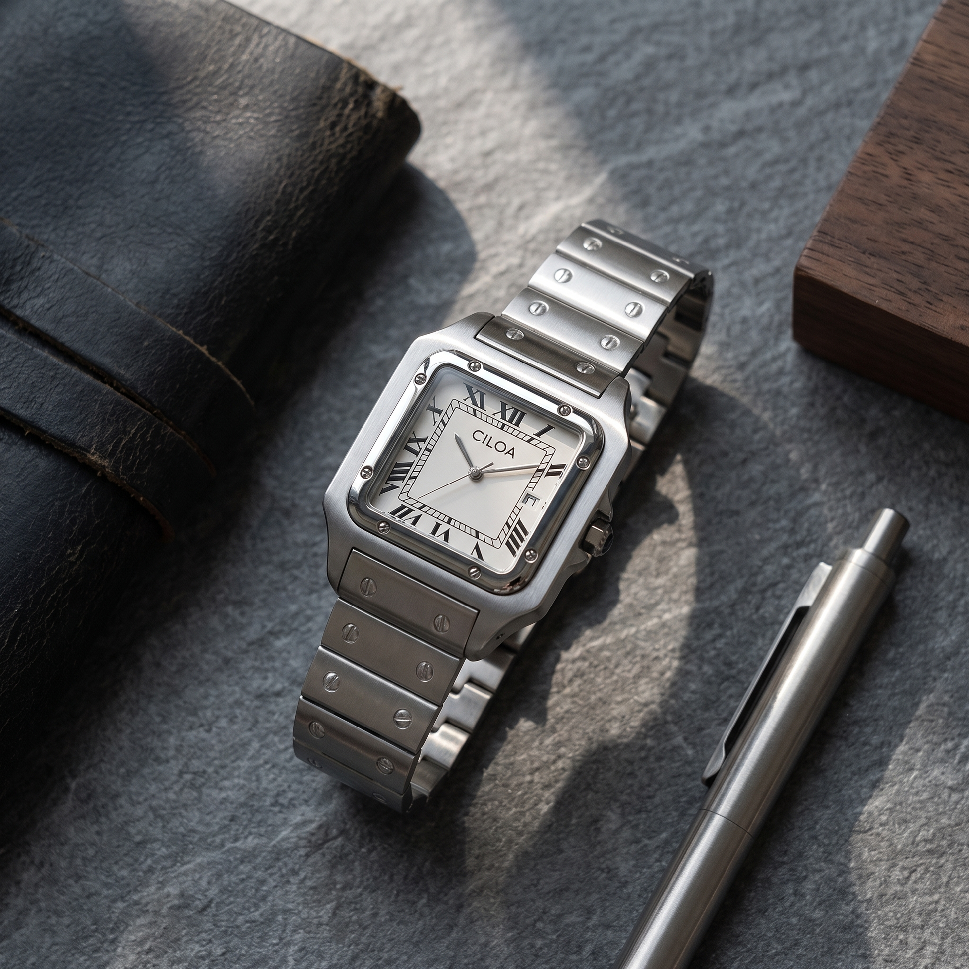 Ellis Steel Bracelet Square Watch styled flat lay on slate with leather notebook