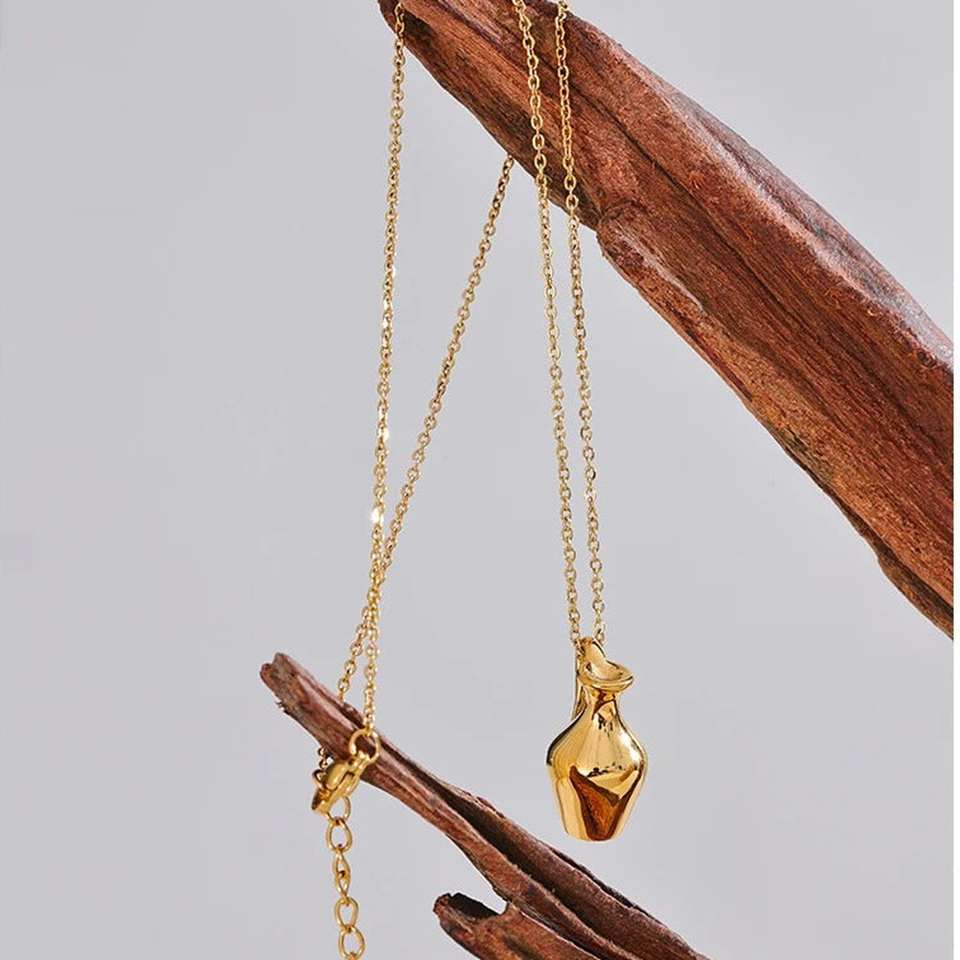 Ravello vase pendant necklace hanging from driftwood