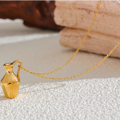 Ravello vase pendant necklace with chain draped on sand