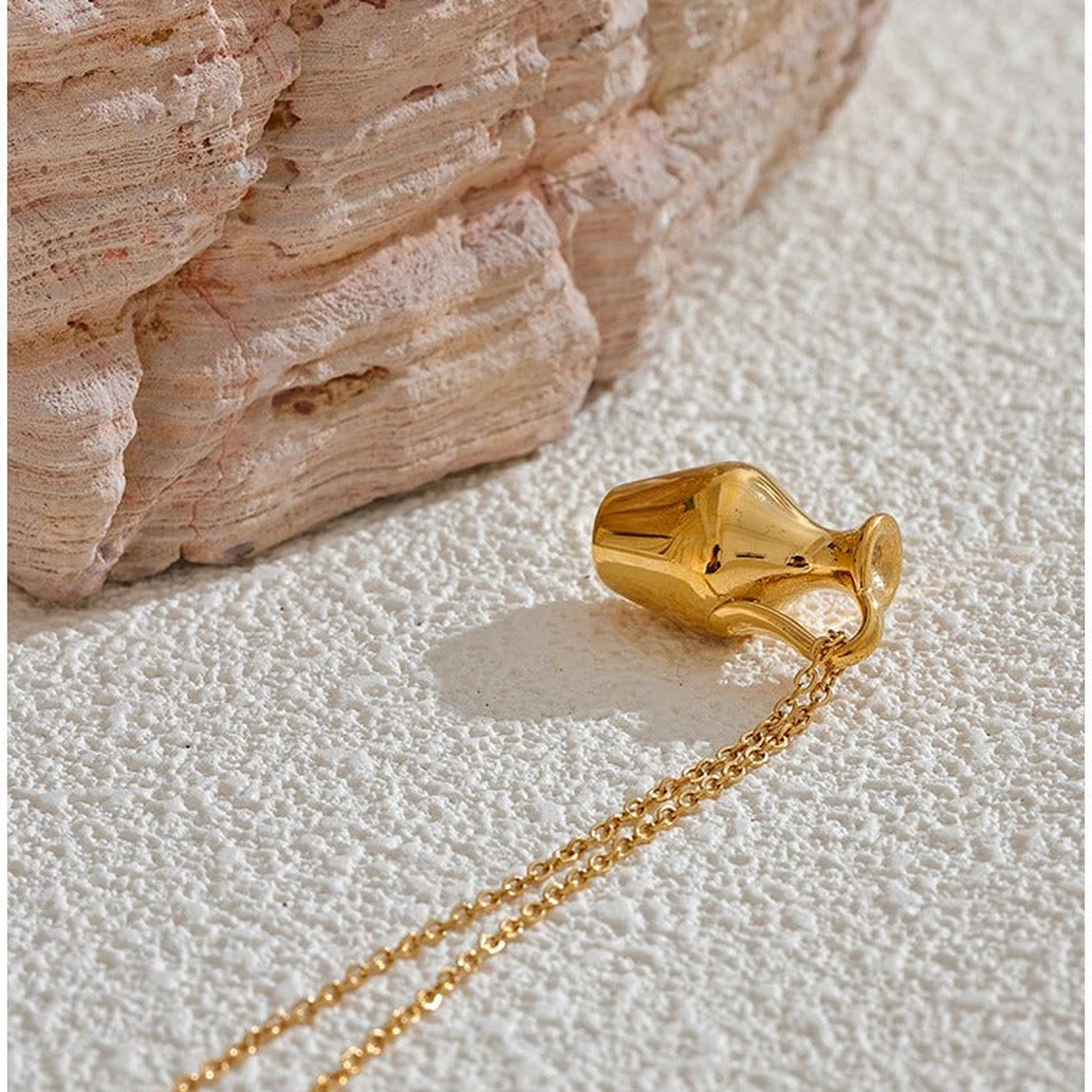 Close view of the Ravello gold-tone vase pendant